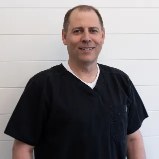 Dr. David Jackson, smiling, in dark scrubs