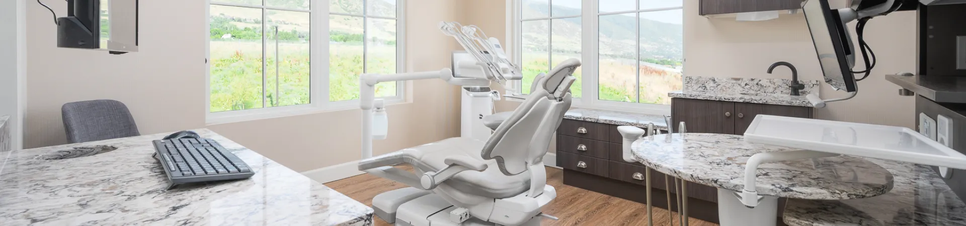A bright Oakridge Dental treatment room with windows looking out to the foothills
